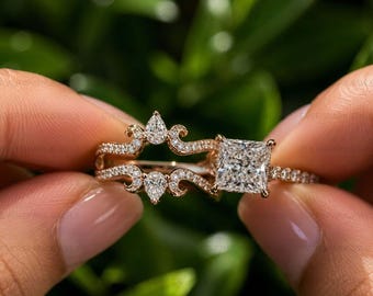 May include: A rose gold ring set featuring a square-cut center stone and a matching contoured band. Both pieces are adorned with small pavé-set stones, including pear-shaped accents on the band, creating a cohesive and detailed jewelry design.