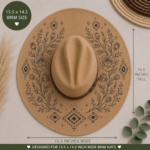 May include: A tan wide-brim hat featuring black line art of roses, leaves, and geometric patterns. The hat has a brown band and measures 15.5 inches wide by 14.5 inches tall. The design includes floral motifs and star-like accents on the brim.