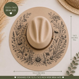 May include: A tan wide-brim hat featuring a black line-art floral pattern with daisies and ladybugs. The hat has a brown band around the crown. Text indicates a 39.4 by 36.8 cm brim size, a 36.8 cm height, and a 39.4 cm width.