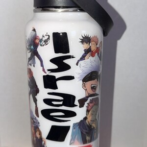 May include: White insulated water bottle featuring anime character illustrations and Japanese text. The bottle has a black lid with a handle and a silver accent. The bottle is on a blue base.