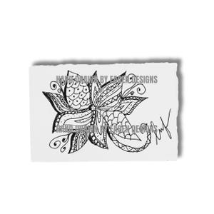 May include: A black and white hand-drawn floral illustration on a piece of paper with a torn edge. The design includes detailed patterns and the text "HAND DRAWN BY EAGEN DESIGNS". A signature is present.