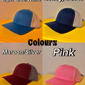 May include: Four baseball caps with mesh backs displayed in a grid. Top left: Light Blue/White cap. Top right: Navy/Silver cap. Bottom left: Maroon/Silver cap. Bottom right: Pink cap. Each hat features a solid front panel and a breathable mesh back.