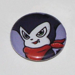 May include: A purple and white cartoon character with a red scarf and fangs. The character has a white background.