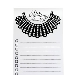 May include: A white notepad with a black and white illustration of a collar and the text "Do Something About It". The notepad has a checklist with 25 blank lines.