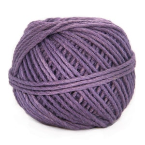 May include: A ball of purple yarn, wound tightly and ready for knitting or crocheting.