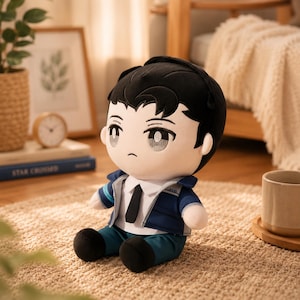 May include: A plush doll featuring a character with short black hair, large grey eyes, and a serious expression. The doll wears a white collared shirt with a black tie, a blue jacket with light blue accents, and dark teal pants, sitting in a seated position.