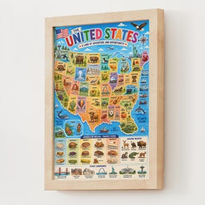 May include: A framed map of the United States titled The United States A Land of Adventure and Opportunity. The map features colorful illustrations of regional wildlife, landmarks, and foods across the states, with a light wood frame border.