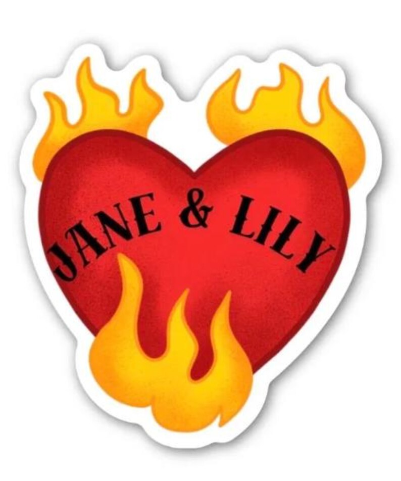 May include: A sticker with a red heart design, displaying the names "JANE & LILY" in black lettering. The heart is encircled by yellow and orange flames. The sticker has a white border.