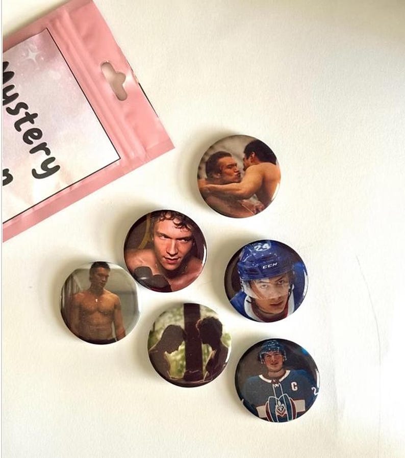 May include: A collection of round pinback buttons featuring images of people and athletes. The buttons have various images, including a hockey player in a blue helmet and jersey, and a pink bag with the word "mystery" on it.