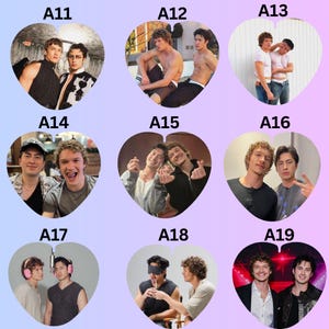 May include: A collection of nine heart-shaped photo prints featuring two men in various poses and settings. Each heart is labeled with a code from A11 to A19, showcasing different outfits, expressions, and activities, including casual wear and formal attire.