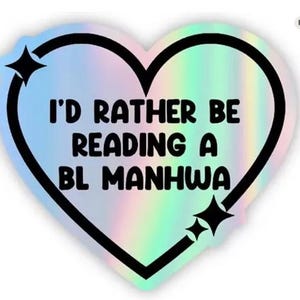 May include: Holographic heart-shaped sticker with a black outline and the text "I'D RATHER BE READING A BL MANHWA". The sticker has a rainbow iridescent effect and two black starburst accents.