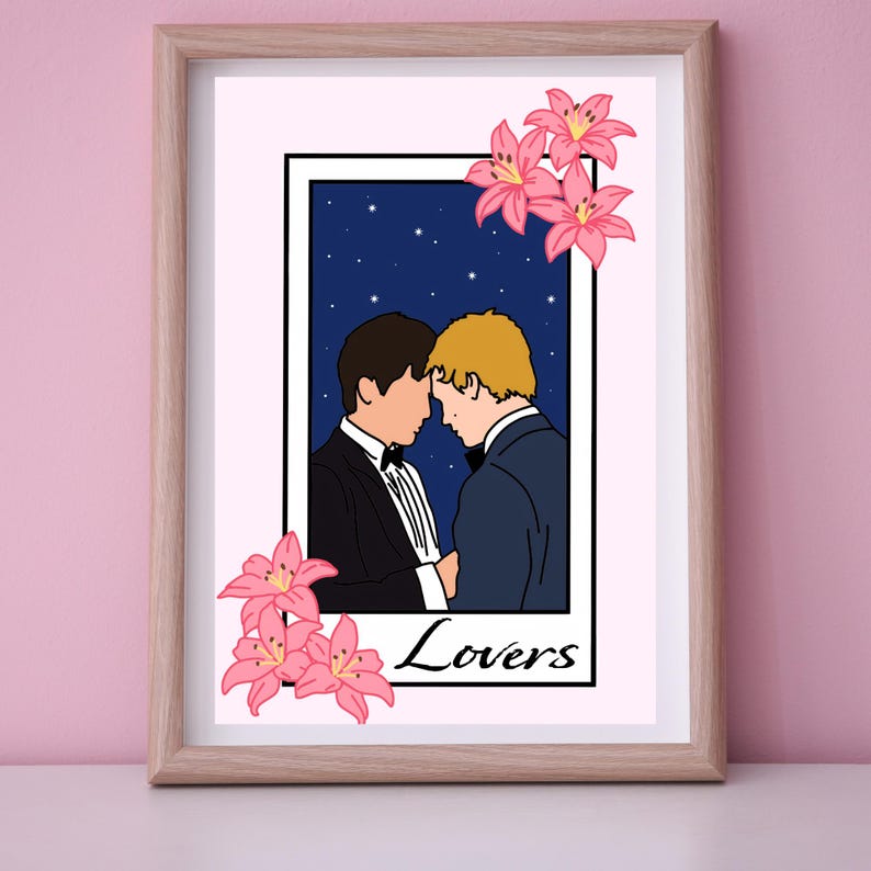 May include: Framed art print featuring a stylized illustration of two people in formal wear, their heads touching, set against a starry night sky. Pink lilies adorn the frame, with the word "Lovers" at the bottom.