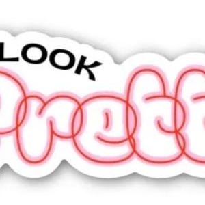 May include: A white sticker featuring the words "YOU LOOK" in black, above the word "Pretty" in a red, bubble-style font with a pink outline. The sticker has a white border.