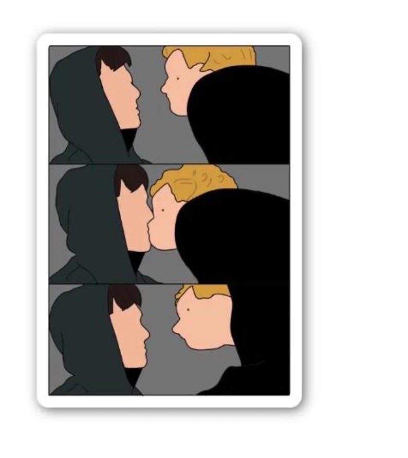 May include: A sticker with a three-panel cartoon illustration. Each panel depicts two figures in profile, one in a dark green hooded top and the other with blonde hair, seemingly kissing. The background is grey.