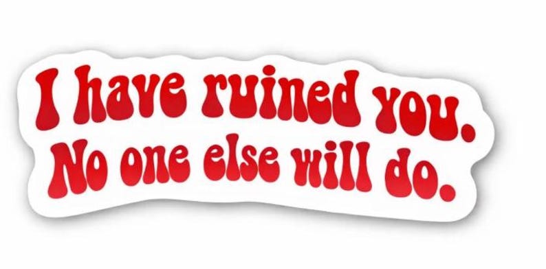 May include: A white sticker with red text that reads, "I have ruined you. No one else will do." The text is in a retro font. The sticker has a rounded, irregular shape, with a white border.