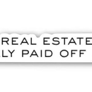 May include: A white sticker with black text. The text reads "YOUR REAL ESTATE fetish REALLY PAID OFF HUH?" The word "fetish" is in a cursive font, the rest is sans-serif.