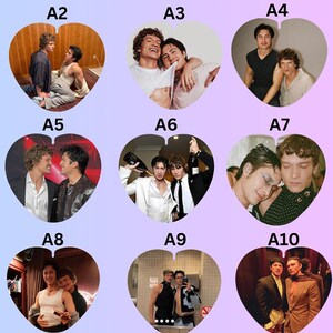 May include: A collection of nine heart-shaped photo prints labeled A2 through A10, each featuring two individuals in various poses and outfits, including formal wear, casual shirts, and tank tops, displayed against a light purple and pink gradient background.