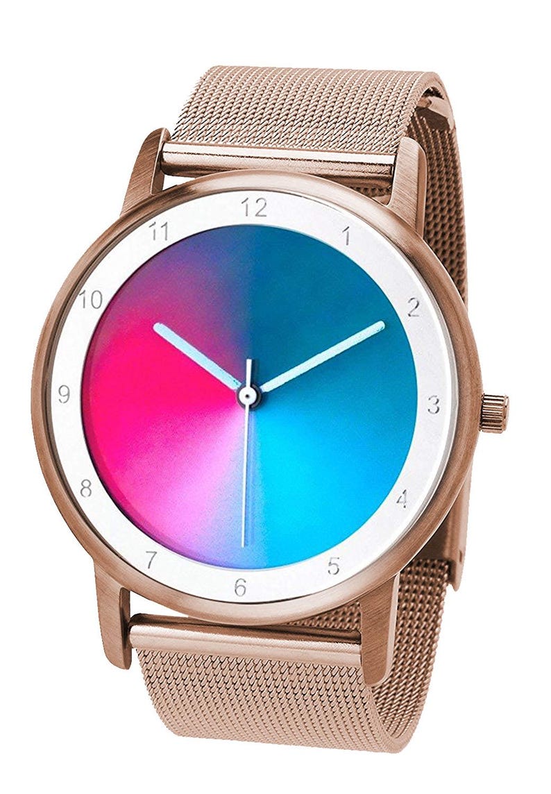 May include: A rose gold wristwatch with a mesh band and a round face. The watch face is divided into two halves, one pink and one blue. White hands and numerals mark the hours.