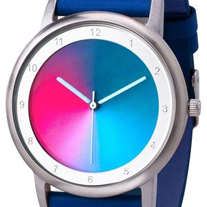 May include: A wristwatch with a silver-tone case and a blue leather band. The watch face features a gradient design of pink, blue, and teal. The watch has white hands and hour markers.