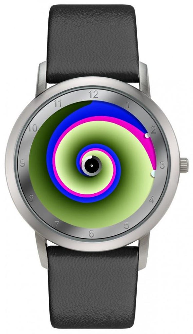 May include: Silver-tone wristwatch with a black leather band. The watch face features a green, blue, and pink spiral design. The watch has a silver bezel and a black leather strap.