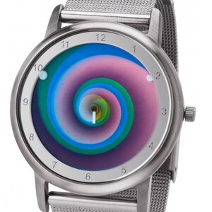 May include: Silver wristwatch with a mesh band and a round face. The watch face features a colorful, swirling spiral design in shades of blue, green, and pink. The watch has a silver bezel and a crown on the side.