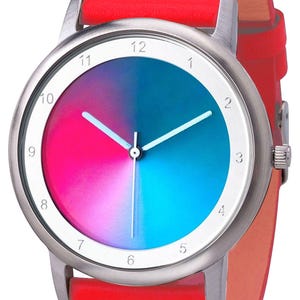 May include: A wristwatch with a silver-colored case and a vibrant, color-blocked face. The watch face is divided into pink and blue sections. It has white hands and a bright red leather band.