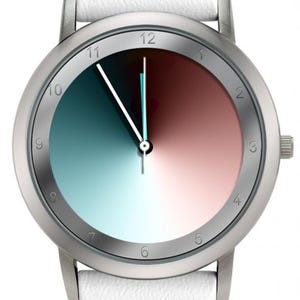 May include: A silver wristwatch with a white leather band. The watch face is divided into two color gradients: teal to blue and red to pink. The watch has silver hands and hour markers.
