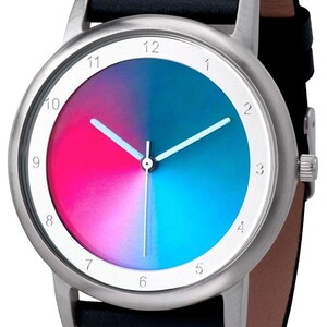 May include: A wristwatch with a silver-colored case and a black leather band. The watch face features a gradient of pink and blue, with white hands and hour markers. The watch band is approximately 0.75 inches wide.