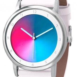 May include: A silver wristwatch with a white leather band. The watch face is divided into pink and blue sections, with white hands and numerals. The watch has a classic, minimalist design.