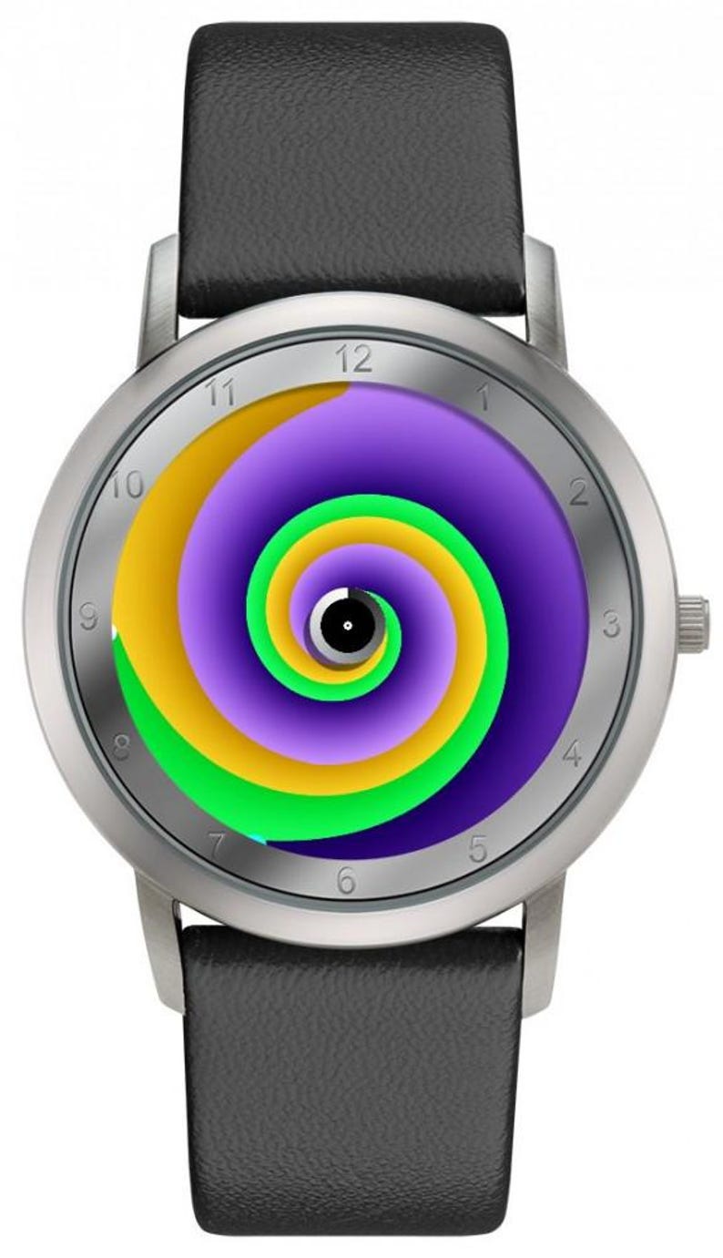 May include: Silver wristwatch with a black leather band. The watch face features a colorful spiral design in yellow, green, and purple. The watch has a silver bezel and a black leather strap.