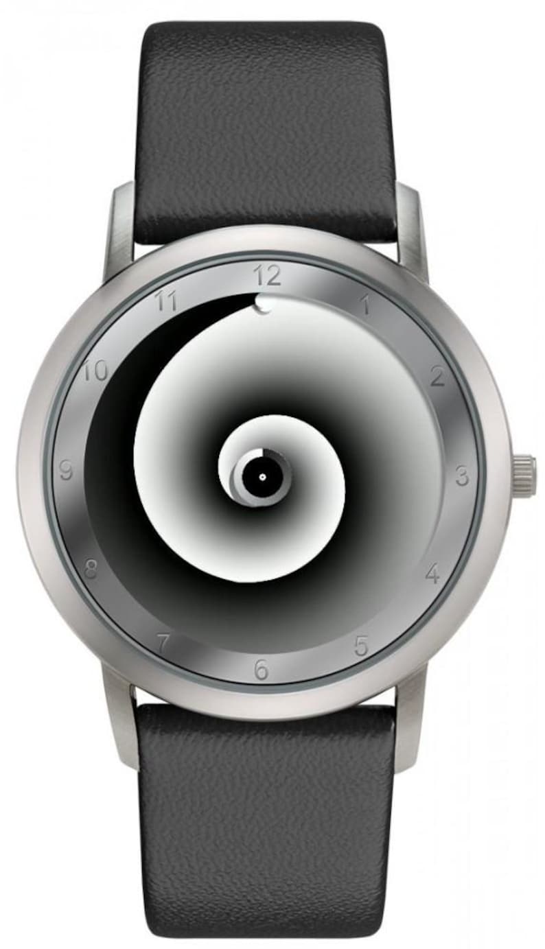 May include: A silver wristwatch with a black leather band. The watch face features a black and white spiral design with silver numerals marking the hours. The watch has a minimalist, modern aesthetic.