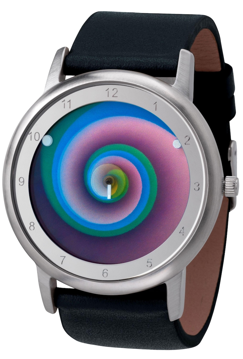 May include: A silver-tone wristwatch with a black leather band. The watch face features a colorful spiral design in shades of blue, green, and pink. The watch has a classic round shape.
