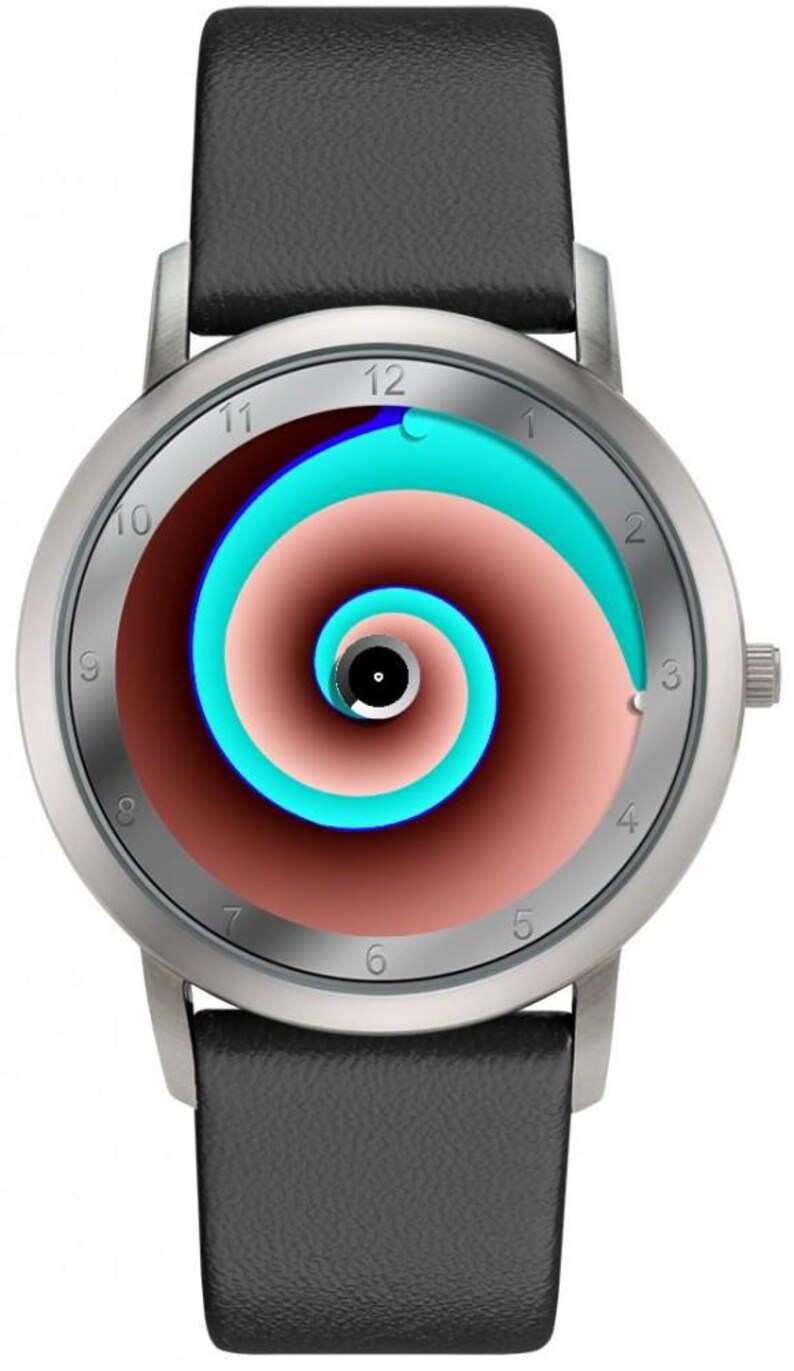 May include: Silver wristwatch with a black leather band. The watch face features a spiral design in shades of brown, teal, and blue. The watch has silver hands and hour markers. The watch band is 22mm wide.