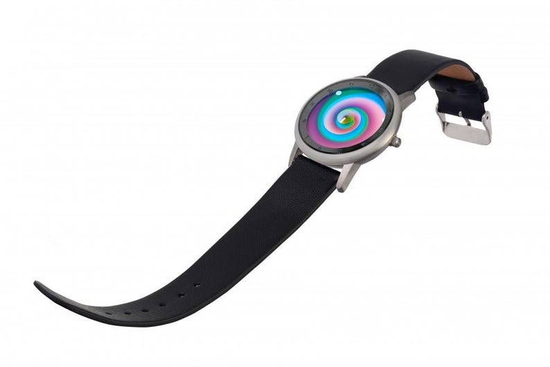 May include: A wristwatch with a black leather band and a silver-colored case. The watch face features a colorful, swirling design with shades of pink, blue, and green. The band is secured with a silver buckle.