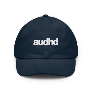May include: A navy blue baseball cap featuring the white text audhd embroidered on the front center. The cap has a structured crown, a curved brim, and stitched eyelets for ventilation, providing a clean and simple design for everyday wear.