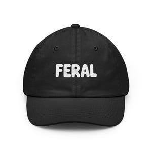 May include: A black baseball cap featuring the word FERAL embroidered in white, bold, rounded capital letters across the front centre. The cap has a structured crown, a curved brim, and stitched eyelets on the top panels for ventilation.