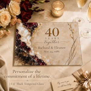 May include: A rectangular tempered glass plaque featuring a beige marble background with a deep red and gold geode-style accent. The text reads 40 YEARS together, Richard & Eleanor, May 24, 1986. The glass is 0.64 cm thick and has a smooth finish.