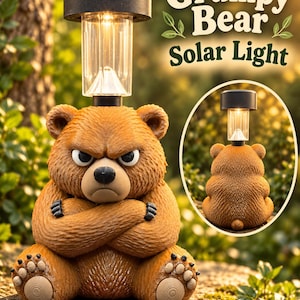 May include: A brown bear figurine with a grumpy facial expression and crossed arms, featuring a solar-powered light fixture on its head. The text Grumpy Bear Solar Light is visible. A circular inset shows the back view of the bear with a small tail.