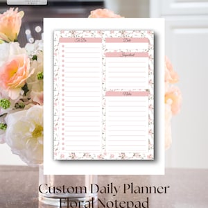 May include: A rectangular daily planner notepad featuring a floral border with pink flowers and green leaves. The layout includes sections labeled To Do with checkboxes, Date, Important, and Notes, all with horizontal lines for writing tasks.