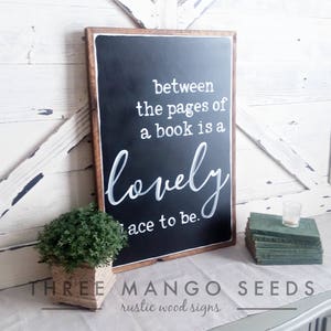 Between the pages of a book is a lovely place to be framed wood sign / 17 x 25 / Black / White / Sign