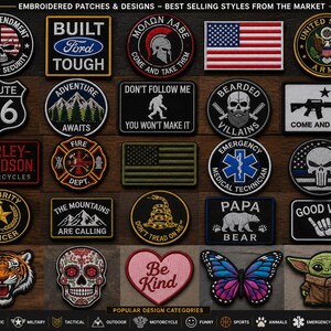May include: A collection of twenty-five embroidered patches featuring diverse designs including American flags, skulls, military emblems, nature scenes, text like Built Ford Tough, Route 66, and Be Kind, plus a butterfly and a green alien character.