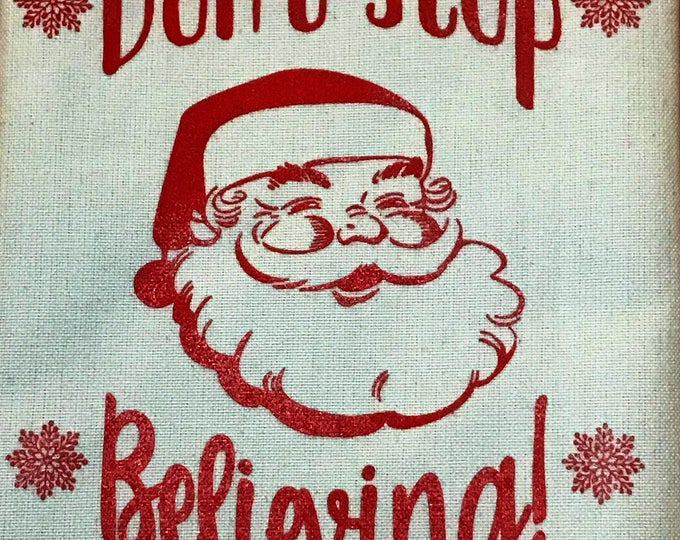 Don't stop believing Santa dish towel