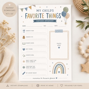 May include: A printable 21.6 cm by 27.9 cm birthday interview questionnaire titled My Child's Favorite Things. The white sheet features blue and tan text, a photo frame, and illustrations of balloons, stars, and a rainbow for recording memories.