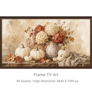 May include: A digital artwork for a television screen featuring a rustic still life with white pumpkins, a weathered ceramic pitcher filled with cream and rust-colored hydrangea flowers, and scattered autumn leaves on a wooden surface.