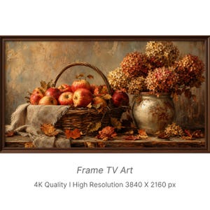 May include: A digital artwork titled Frame TV Art, 4K Quality | High Resolution 3840 X 2160 px, depicting a still life with a woven basket filled with red apples, a ceramic vase holding dried hydrangea flowers, and scattered autumn leaves.