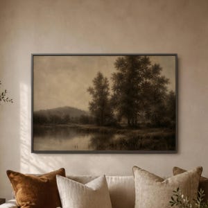 May include: A sepia-toned landscape painting in a dark frame. The artwork depicts a serene scene with a body of water, trees, and a distant hill under a cloudy sky. The painting evokes a sense of tranquility and natural beauty.