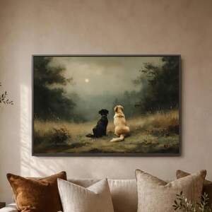 May include: A rectangular wall art print in a dark frame depicting a black dog and a golden-colored dog sitting side by side in a grassy field, looking toward a misty forest under a pale moon in a muted, atmospheric, and painterly landscape scene.