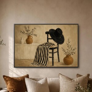 May include: A framed oil painting depicting a black hat resting on a dark wooden chair draped with a black and white striped throw. Two terracotta-coloured vases containing leafy branches sit on a ledge, all set against a neutral beige background.