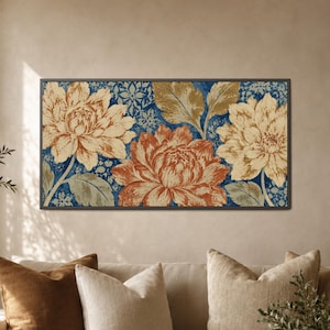 May include: A rectangular wall art piece featuring three large, detailed flowers in shades of cream, tan, and burnt orange. The floral arrangement is set against a deep blue background with a subtle, intricate, repeating geometric pattern.