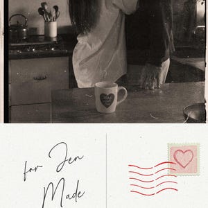 May include: A sepia-toned image of a couple kissing in a kitchen. A mug with a heart design and the words "Made with love" is on the counter. A postcard with the text "for Jen Made with love" and "I got you the perfect gift" is also shown.